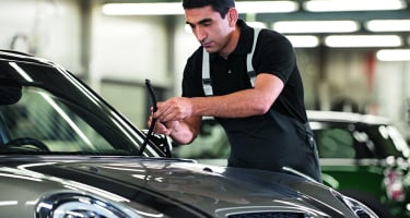 Certified MINI Technician performs routine vehicle maintenance