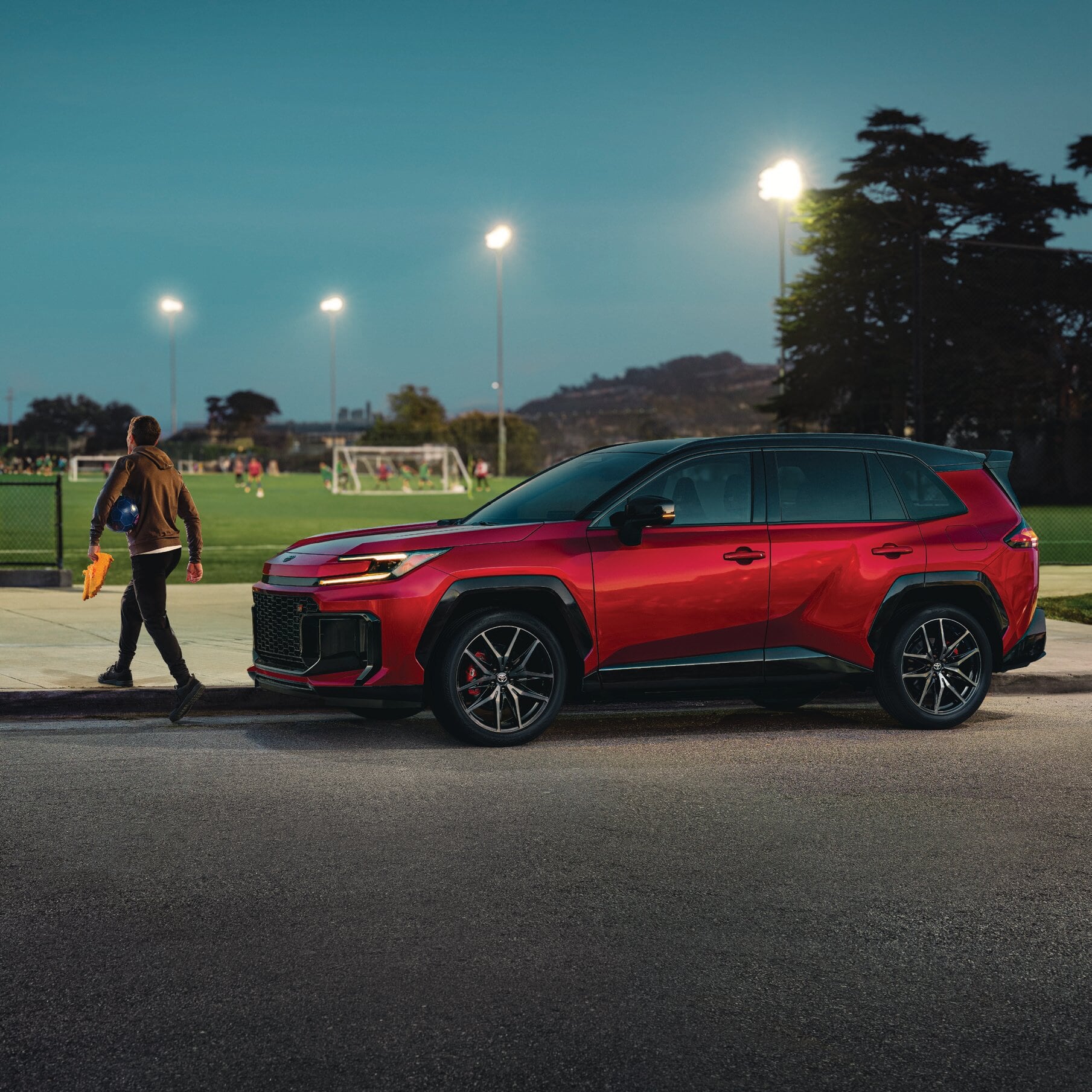 Man walking his son to their Toyota vehicle.